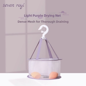 Close-up of a light purple mesh drying net for makeup sponges with orange blenders inside