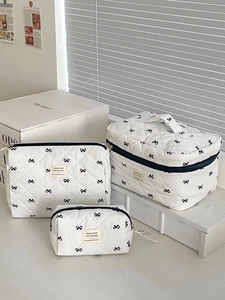 Three-piece quilted makeup bag set with black bow patterns and elegant top handles