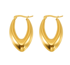 Macro detail of polished gold teardrop hoop earrings showing smooth metallic texture