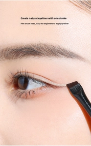 Macro shot of an angled eyeliner brush defining the lower lash line for professional eye makeup