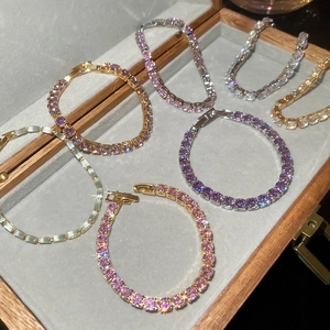 Close-up of sparkling tennis bracelets with colorful zircons in a premium jewelry box