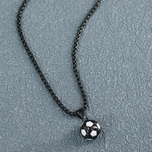Detailed macro view of black box chain necklace with black and white enamel soccer ball pendant