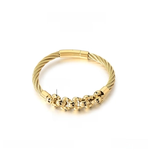 Macro view of gold stainless steel skull bracelet with cable wire design and dimensions