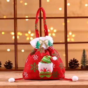 Red Christmas drawstring gift bag with a snowman doll and festive wooden background