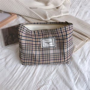 Detail showing vintage plaid fabric pouch with Time to Party label on white cloth