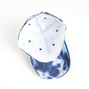 Detail of blue tie-dye baseball cap interior showing white lining and metal buckle