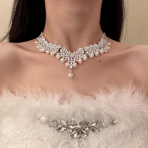 Detailed view of elegant silver flower necklace and jewelry set with pearls and crystals