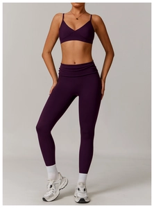 Detail of high-waist yoga leggings with wide folded waistband and purple matte fabric