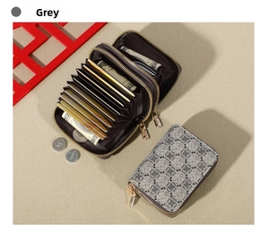 Close-up of grey clover patterned double zipper wallet with accordion card slots