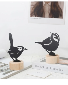 Set of two black metal bird silhouette ornaments with natural wood bases for desk decor