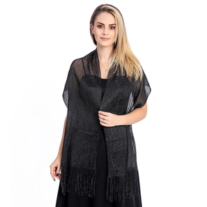 Detail of elegant black metallic yarn shawl with long tassels for evening wedding parties