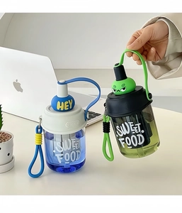 Detail view of blue and green portable plastic tea cups with strainer and cartoon designs