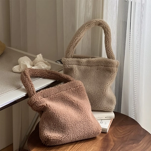 Detailed close-up of soft plush lamb wool handbags in light coffee and brown colors