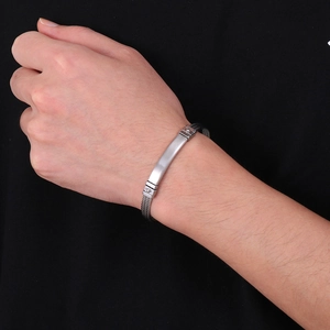 Men's titanium steel cable bracelet with brushed silver bar on dark braided wire band