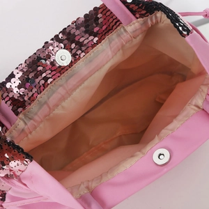 Detail of pink sequin kids bag showing beige lining and magnetic silver metal closure