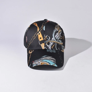 Close-up of black baseball cap featuring vintage gold chain prints and classic curved brim