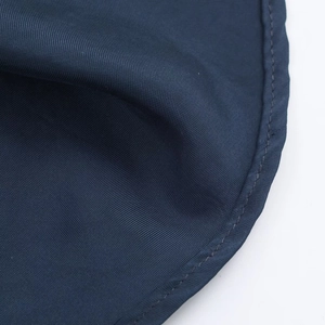 Gros plan détaillé du tissu en satin bleu foncé avec tissage sergé et coutures professionnelles