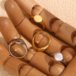 Detail of 18K gold and silver plated stainless steel rings engraved with You Are Gold