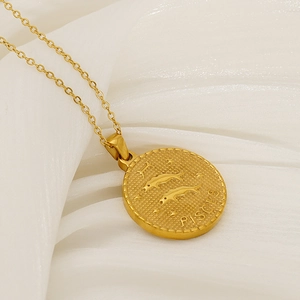 Detailed close-up of gold Pisces zodiac coin pendant with intricate relief and fine chain
