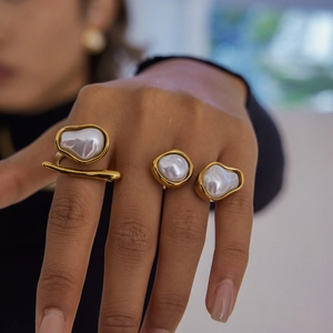 Baroque irregular pearl ring set in gold plated stainless steel worn on hand