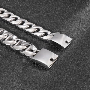 Detailed macro view of the silver stainless steel Cuban link chain with secure box clasp