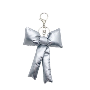 Metallic silver puffed ribbon bow keychain with shiny finish and metal clasp clip
