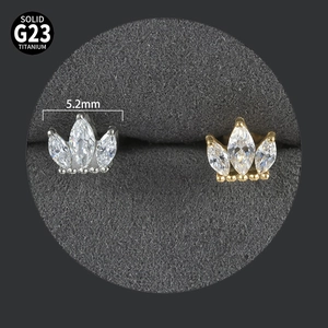 Detail of 5.2mm crown-shaped G23 titanium labret studs with silver and gold finishes