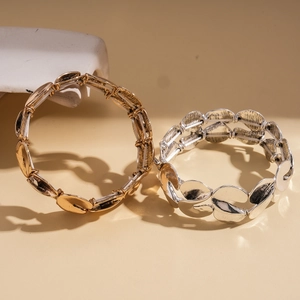 Minimalist S-shaped twisted elastic bracelets in gold and silver textured metal finishes