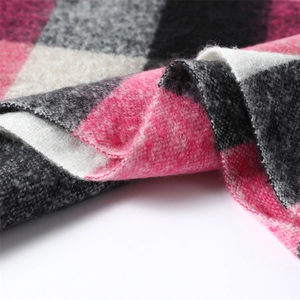 Close-up of soft plaid scarf fabric showing pink and grey cashmere-like weave textures