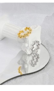 Detailed shot of gold and silver minimalist bead rings with 925 silver stamp engraving