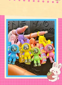 Hand showing four colorful mechanical astronaut bunny keychains as cute bag accessories