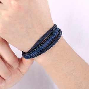 Detail of multi-layer woven leather bracelet in navy and black with magnetic metal clasp