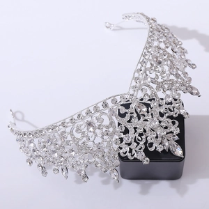 Detailed close-up of a luxury silver bridal crown with intricate crystal and rhinestone inlay