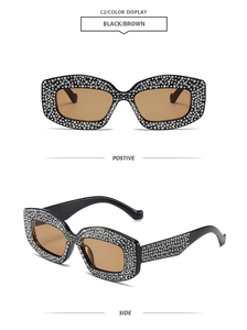 Detail view of rhinestone-encrusted rectangle sunglasses in black frame with brown lenses