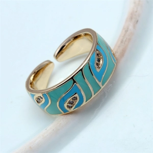 Detailed macro view of gold evil eye ring with light blue enamel and sparkling zircon