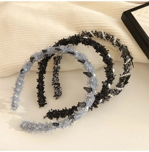 Close-up of tweed wave headbands with pearls and metallic studs for women