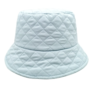 Close-up of light blue quilted bucket hat featuring diamond-stitched padded fabric textures