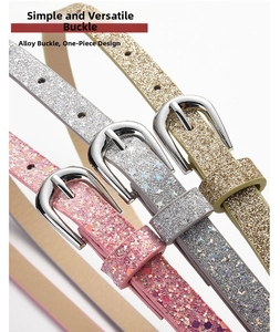 Detail of glitter ladies belts with alloy pin buckles in pink, silver, and gold colors