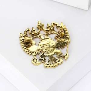 Detailed back view showing the safety pin fastener and gold alloy eagle brooch texture