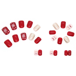 Short Christmas press-on nails set featuring cute reindeer, snowflakes and red glitter