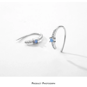 Detail view of S925 silver hoop earrings with a light blue opal and cubic zirconia