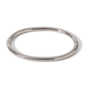 Detail view of silver minimalist stainless steel bangle with circular hinge clasp design