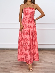 Detail of coral pink halter neck maxi dress with tropical red palm tree print and layered skirt