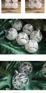 Detail of transparent Christmas ball ornament with white frosted snow tree and Merry Christmas text