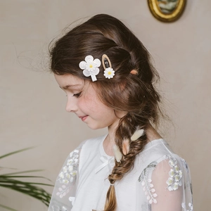 Cute embroidered white flower and daisy hair clips set on a little girl's hair
