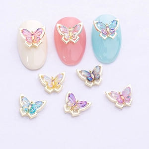 Chic butterfly nail art charms with iridescent aurora wings and gold metal frame decor