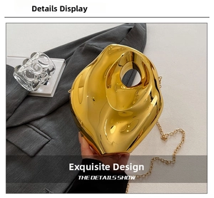 Macro view of gold irregular fluid-shaped acrylic clutch with metallic mirror finish