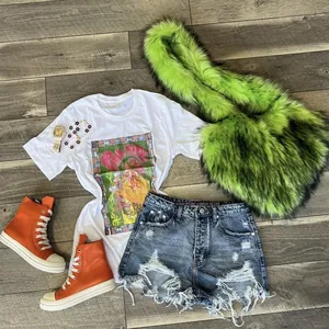 Flat lay of y2k street outfit with faux fur crossbody bag and vintage heart shell bag