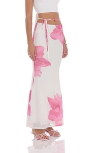 Detail of elegant mesh skirt featuring pink floral print and tie-waist on high-quality fabric