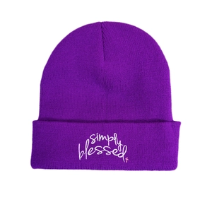 Detail of purple beanie with white Simply Blessed embroidery and pink cross accent